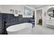 Modern bathroom featuring a freestanding tub, dark tile accent wall, and contemporary fixtures at 1897 Halo Ln, Charleston, SC 29407