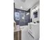 Modern bathroom featuring a white vanity and a glass door shower with navy tile at 1897 Halo Ln, Charleston, SC 29407