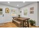 Bright dining room featuring a wooden table, bench seating, and natural light from the surrounding windows at 1897 Halo Ln, Charleston, SC 29407