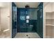 Modern glass enclosed shower featuring blue subway tile and a white tile floor at 1897 Halo Ln, Charleston, SC 29407