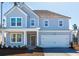 Charming two-story home featuring a light blue exterior, attached garage, and welcoming front porch at 193 Belfort Pl, Summerville, SC 29486