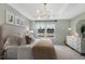 Cozy bedroom featuring a tray ceiling, large windows overlooking a lake, and elegant decor at 195 Belfort Pl, Summerville, SC 29486