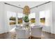 Bright dining area with large windows providing scenic views and a stylish chandelier creating an inviting space at 195 Belfort Pl, Summerville, SC 29486
