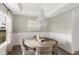 Formal dining room with elegant wainscoting, a decorative chandelier, and a round table for intimate gatherings at 195 Belfort Pl, Summerville, SC 29486