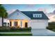 Charming single-Gathering home featuring a covered front porch, well-manicured lawn, and an attached two-car garage at 195 Belfort Pl, Summerville, SC 29486