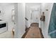 Bright hallway with wood floors leading to the staircase, laundry, and the home's entry door at 195 Belfort Pl, Summerville, SC 29486
