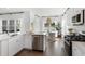 Modern kitchen featuring stainless steel appliances, dark hardwood floors, white cabinets, and an adjacent dining area at 195 Belfort Pl, Summerville, SC 29486