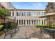 Spacious backyard with a brick patio, lush greenery, and plenty of natural light at 2 Bedons Aly, Charleston, SC 29401
