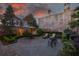 Serene backyard oasis features a stone patio, lush greenery, and a brick privacy wall at 2 Bedons Aly, Charleston, SC 29401