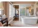 Luxurious bathroom featuring a soaking tub, vanity with a mirror, and decorative tile flooring at 2 Bedons Aly, Charleston, SC 29401