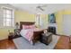 Bright bedroom features a king bed, fireplace, and natural light from multiple windows at 2 Bedons Aly, Charleston, SC 29401