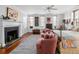 Spacious bedroom featuring hardwood floors, a fireplace, two chairs, and several windows at 2 Bedons Aly, Charleston, SC 29401