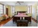 Inviting bedroom with wooden floors, king bed, windows, and a decorative area rug at 2 Bedons Aly, Charleston, SC 29401