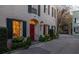 Charming entrance featuring a red door, decorative window, and vibrant flower boxes at 2 Bedons Aly, Charleston, SC 29401