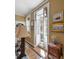 Entryway with beautiful lighting, a marble top entry table, and a view to a balcony at 2 Bedons Aly, Charleston, SC 29401