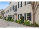 Beautifully landscaped home featuring black shutters, flower boxes, and a red front door at 2 Bedons Aly, Charleston, SC 29401