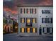 Elegant three-story townhome with black shutters and charming street appeal, showcasing classic architecture at 2 Bedons Aly, Charleston, SC 29401