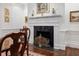 Bright white fireplace mantel with black stone and dark hardwood floors offer a warm and inviting ambiance at 2 Bedons Aly, Charleston, SC 29401