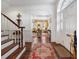 Welcoming foyer with hardwood floors, elegant staircase, and a view into the living spaces at 2 Bedons Aly, Charleston, SC 29401