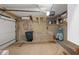 Spacious garage with overhead lighting, a trash receptacle, and exposed brick at 2 Bedons Aly, Charleston, SC 29401