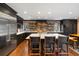 Bright kitchen boasting a large island with seating, stainless steel appliances, and modern lighting at 2 Bedons Aly, Charleston, SC 29401