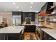 This kitchen features a brick backsplash, stainless appliances, and a large island with a sink at 2 Bedons Aly, Charleston, SC 29401