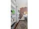Laundry room with stackable washer and dryer, shelving, and unique exposed brick accent wall at 2 Bedons Aly, Charleston, SC 29401