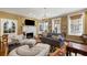 Comfortable living room with fireplace, television, and ample seating with lovely natural light at 2 Bedons Aly, Charleston, SC 29401