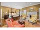 Spacious main bedroom with sitting area features hardwood floors, a four-poster bed, and ample natural light at 2 Bedons Aly, Charleston, SC 29401