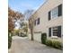 Exterior street view of townhomes featuring two-car garages and mature trees at 2 Bedons Aly, Charleston, SC 29401