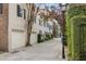 Exterior street view of townhomes featuring two-car garages and mature trees at 2 Bedons Aly, Charleston, SC 29401