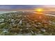Scenic aerial view showcasing the beautiful neighborhood with the ocean and a stunning sunset at 2 Wills Way, Isle of Palms, SC 29451