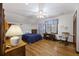 Comfortable bedroom featuring a bed, wood floors, desk, chair, ceiling fan, and natural light at 2 Wills Way, Isle of Palms, SC 29451