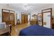 Bright bedroom features wood floors, a large bed, wooden doors, a desk, and a ceiling fan at 2 Wills Way, Isle of Palms, SC 29451