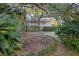Exterior of a charming home with mature trees and lush landscaping provides privacy and curb appeal at 2 Wills Way, Isle of Palms, SC 29451