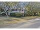 Charming home with mature trees, lush landscaping, and an inviting front porch at 2 Wills Way, Isle of Palms, SC 29451