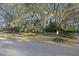 Exterior of a charming home featuring mature trees and lush landscaping, creating a serene setting at 2 Wills Way, Isle of Palms, SC 29451