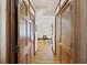Hallway view of wood-finished doors and hardwood floors leading into a bright room with natural light at 2 Wills Way, Isle of Palms, SC 29451
