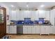 Well-lit kitchen with white cabinetry, modern appliances, and a view to the outside, perfect for cooking and entertaining at 2 Wills Way, Isle of Palms, SC 29451