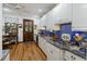 Modern kitchen featuring white cabinets, stainless steel appliances, granite counters, and blue tile backsplash at 2 Wills Way, Isle of Palms, SC 29451
