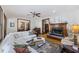 Bright living room showcasing a white sectional sofa, fireplace, and hardwood floors at 2 Wills Way, Isle of Palms, SC 29451