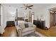 Spacious main bedroom with a four poster bed, hardwood floors, sitting area, and natural light at 2 Wills Way, Isle of Palms, SC 29451