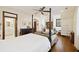 Bright main bedroom featuring a four poster bed, hardwood floors, and comfortable sitting area at 2 Wills Way, Isle of Palms, SC 29451