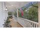 Inviting porch with railing, plants, and an American flag, creating a welcoming outdoor space at 2 Wills Way, Isle of Palms, SC 29451