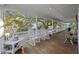 Spacious, covered porch with rocking chairs offers an inviting outdoor seating area for relaxing at 2 Wills Way, Isle of Palms, SC 29451