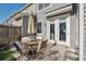 Cozy back patio with table, chairs, patterned rug and sun umbrella at 202 Kirkland St, Goose Creek, SC 29445
