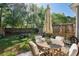 Relaxing fenced backyard featuring a patio set, lush lawn and landscaping at 202 Kirkland St, Goose Creek, SC 29445