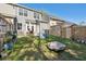 Wide fenced backyard with patio, chairs, lounge and well-manicured lawn at 202 Kirkland St, Goose Creek, SC 29445