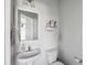 Neutral toned powder room with pedestal sink and storage at 202 Kirkland St, Goose Creek, SC 29445