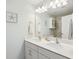 Bathroom featuring double vanity with white cabinets, quartz countertop, and decorative wall art at 202 Kirkland St, Goose Creek, SC 29445
